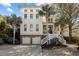 Charming multi-story home boasting palm trees, a two-car garage, and inviting entry steps at 4008 Cameron Blvd, Isle of Palms, SC 29451