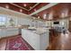 Bright kitchen with a central island, white cabinets, granite countertops, and views of the living spaces at 4008 Cameron Blvd, Isle of Palms, SC 29451