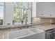 This kitchen features a farmhouse sink, granite countertops, and modern fixtures at 4008 Cameron Blvd, Isle of Palms, SC 29451