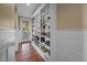 Bright living room features built-in bookshelves, a door to the outside, and gleaming hardwood floors at 4008 Cameron Blvd, Isle of Palms, SC 29451