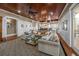 Open-concept living room with a large sectional, wood floors, and access to dining and kitchen areas at 4008 Cameron Blvd, Isle of Palms, SC 29451