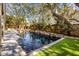 Beautiful backyard pool with lush landscaping and built-in waterfall feature. Perfect for relaxation and entertaining at 4008 Cameron Blvd, Isle of Palms, SC 29451