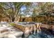 Stunning backyard pool and spa featuring stone accents, waterfall feature, and lush landscaping at 4008 Cameron Blvd, Isle of Palms, SC 29451