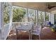 Covered porch features outdoor dining set, ceiling fan and ample space for relaxing or entertaining at 4008 Cameron Blvd, Isle of Palms, SC 29451