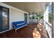 Relax on this beautiful porch with a comfortable blue couch overlooking the lush, green landscape at 4008 Cameron Blvd, Isle of Palms, SC 29451