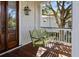 Comfortable green wooden swing hanging from a porch with wood flooring and white railings and trim at 4008 Cameron Blvd, Isle of Palms, SC 29451