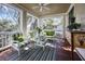 Screened porch features ample seating with stylish, green and white striped furniture, perfect for relaxation at 4008 Cameron Blvd, Isle of Palms, SC 29451