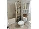 Bathroom features a tub-shower with decorative curtain, toilet and cabinet at 415 Aberdeen Cir, Summerville, SC 29483