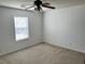A bright, carpeted bedroom features a ceiling fan and natural light from a window at 415 Aberdeen Cir, Summerville, SC 29483
