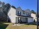 View of a well-kept two-story home with a two-car garage and manicured landscaping at 415 Aberdeen Cir, Summerville, SC 29483