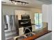 Bright kitchen with stainless steel appliances, black countertops, and white cabinets at 415 Aberdeen Cir, Summerville, SC 29483