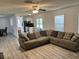 Open-concept living room with a large couch and view of the kitchen and dining room at 415 Aberdeen Cir, Summerville, SC 29483