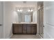 Modern bathroom featuring double sink vanity, large mirror, and glass enclosed shower at 416 Duskywing Dr, Goose Creek, SC 29445