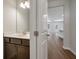 Powder room with undermount sink and wood cabinet, adjacent to a large living space at 416 Duskywing Dr, Goose Creek, SC 29445