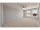 Spacious bedroom with carpeted floor, modern ceiling fan, and two windows at 416 Duskywing Dr, Goose Creek, SC 29445
