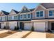 Charming townhomes feature stone accents, attached garages, and well-manicured landscaping at 416 Duskywing Dr, Goose Creek, SC 29445