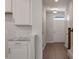 Bright hallway features hardwood floors and modern white cabinets with granite countertops at 416 Duskywing Dr, Goose Creek, SC 29445