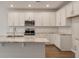 Bright kitchen with white cabinets, stainless appliances, granite countertops, and hardwood floors at 416 Duskywing Dr, Goose Creek, SC 29445