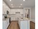 Bright open kitchen with white cabinets, stainless steel appliances, and granite countertops at 416 Duskywing Dr, Goose Creek, SC 29445