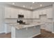 Modern kitchen with white cabinets, stainless appliances, granite countertops, and hardwood floors at 416 Duskywing Dr, Goose Creek, SC 29445