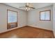 Sunlit bedroom with hardwood floors, white walls, ceiling fan and dual windows at 417 Judy Dr, Goose Creek, SC 29445