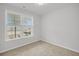 Bright, carpeted bedroom with view from double windows of exterior landscaping and the street at 419 Grove End Rd, Moncks Corner, SC 29461
