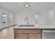 Kitchen island featuring stainless steel sink, granite counter, and shaker cabinets at 419 Grove End Rd, Moncks Corner, SC 29461