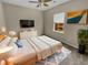 Cozy bedroom featuring a ceiling fan, neutral walls, and a large window, offering a serene and relaxing space at 431 Eva St, Moncks Corner, SC 29461