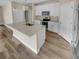 Modern kitchen with island, stainless steel appliances, white cabinetry and granite countertops at 431 Eva St, Moncks Corner, SC 29461