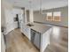 Bright kitchen boasts white cabinetry, stainless steel appliances, a central island and an open concept layout at 431 Eva St, Moncks Corner, SC 29461