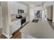Modern kitchen featuring a central island, stainless steel appliances, and sleek white cabinetry at 431 Eva St, Moncks Corner, SC 29461