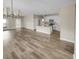 Bright, open-concept living area features a spacious floor plan, kitchen with white cabinets, and lots of natural light at 431 Eva St, Moncks Corner, SC 29461