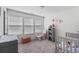 Bright Bedroom with a crib, rocker, changing table and many windows at 458 Pender Woods Dr, Summerville, SC 29486