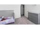 Charming bedroom featuring a crib, dresser, and closet at 458 Pender Woods Dr, Summerville, SC 29486