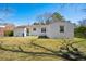 Backyard with white painted brick, a blue recycling bin, and a large grassy area at 511 Sarah St, Charleston, SC 29407