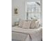 Bedroom with a white bed, neutral pillows, and a large window for ample natural light at 511 Sarah St, Charleston, SC 29407