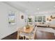 Open dining area with hardwood floors, modern dining table and chairs, flowing into the living room at 511 Sarah St, Charleston, SC 29407