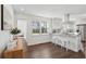 Eat-in kitchen with stainless appliances, white cabinets, seating area, and hardwood floors at 511 Sarah St, Charleston, SC 29407