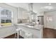 Bright kitchen with a stainless steel hood vent, white cabinets, and quartz countertops at 511 Sarah St, Charleston, SC 29407