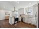 Modern kitchen with stainless steel appliances, white cabinets, and hardwood floors in an open layout at 511 Sarah St, Charleston, SC 29407