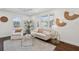 A cozy living room with hardwood floors, a comfortable sofa, an armchair, and plenty of natural light at 511 Sarah St, Charleston, SC 29407