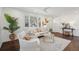 Bright living room with modern decor, hardwood floors, a ceiling fan, and ample natural light from the large windows at 511 Sarah St, Charleston, SC 29407