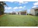 A large backyard boasts a green lawn and multiple screened-in patios at 523 Eastern Isle Ave, Summerville, SC 29486