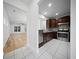 Well-lit kitchen featuring stainless steel appliances and dark wood cabinetry, open to the living area at 523 Eastern Isle Ave, Summerville, SC 29486