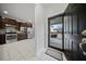 Modern kitchen with stainless steel appliances and dark wood cabinets visible from the entry way at 523 Eastern Isle Ave, Summerville, SC 29486