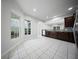 A bright kitchen features dark cabinets, tile backsplash, and stainless steel appliances at 523 Eastern Isle Ave, Summerville, SC 29486