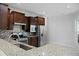 Well-equipped kitchen with stainless steel appliances, granite countertops, wood cabinets, and tile backsplash at 523 Eastern Isle Ave, Summerville, SC 29486