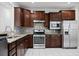 A kitchen with stainless steel appliances, granite countertops, tile backsplash, and wooden cabinetry at 523 Eastern Isle Ave, Summerville, SC 29486