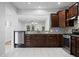 Kitchen features dark wood cabinets, stainless steel appliances, granite countertops, and an open layout at 523 Eastern Isle Ave, Summerville, SC 29486