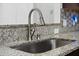 Close-up of a stainless steel sink with a granite countertop and a modern faucet at 523 Eastern Isle Ave, Summerville, SC 29486